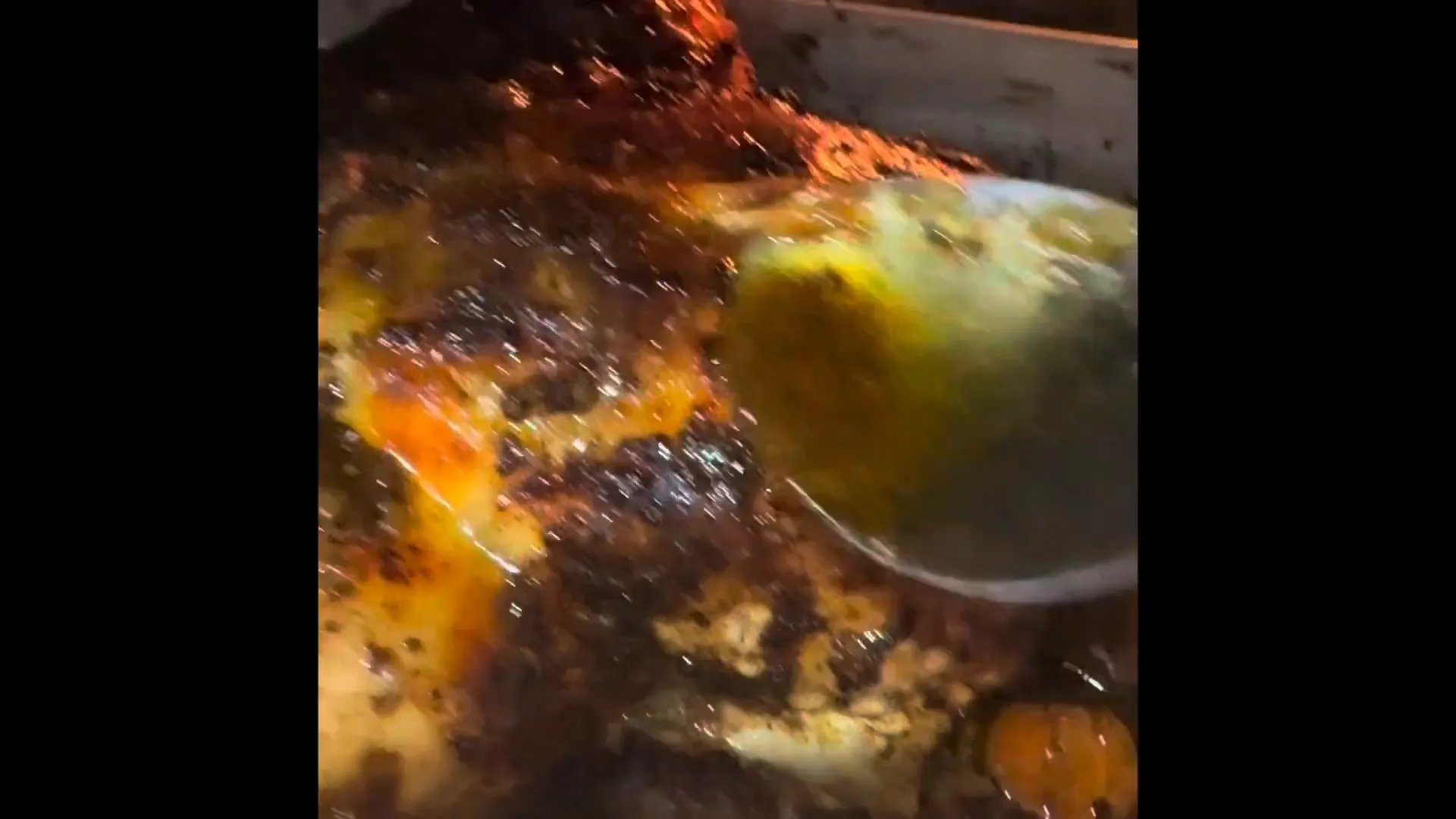 Basting the chicken with its juices