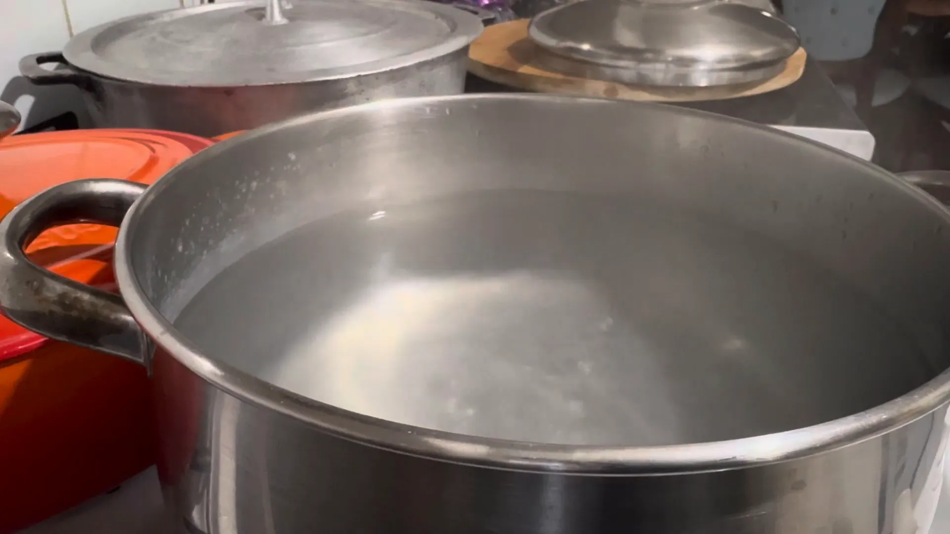 Adding ginger and spices to boiling water