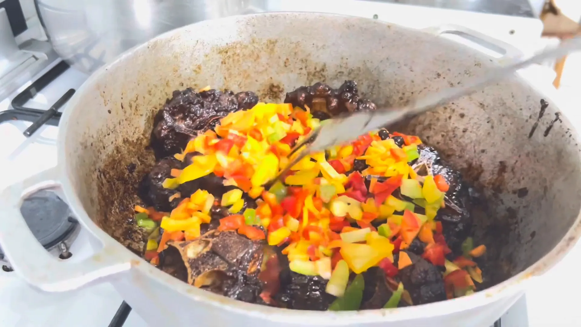 Sautéing onions and peppers in the pot