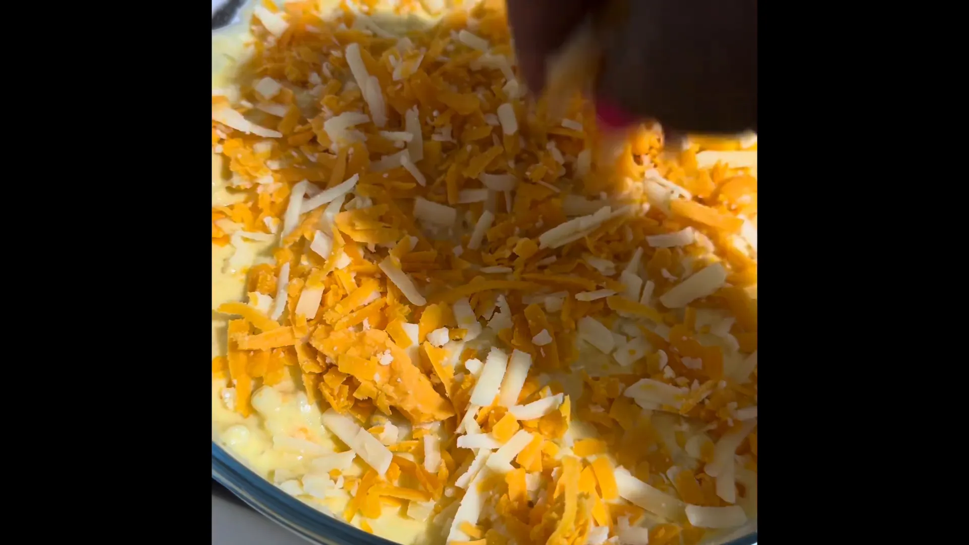 Adding cheese topping before baking
