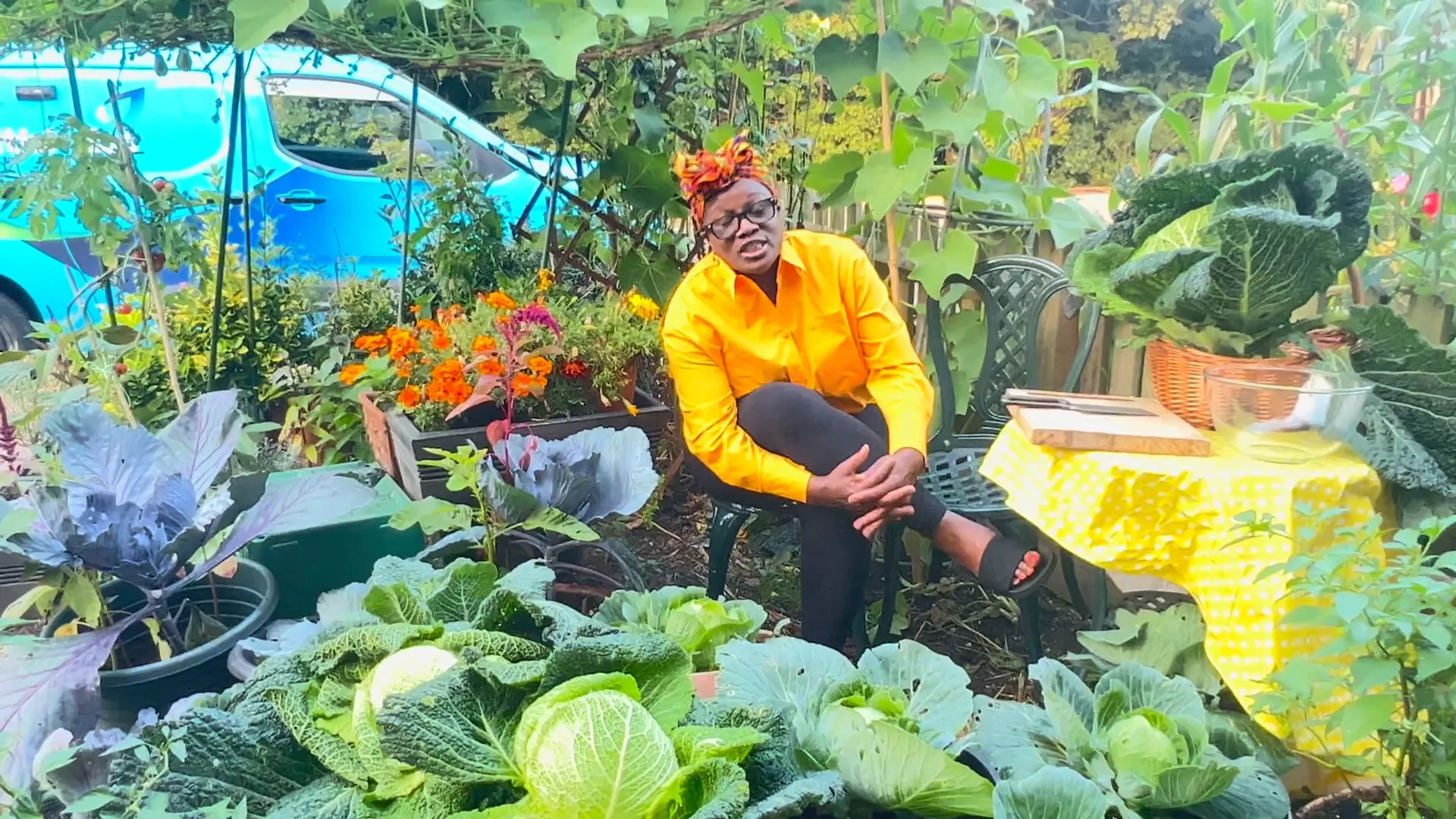 Donna in her garden, smiling with pride