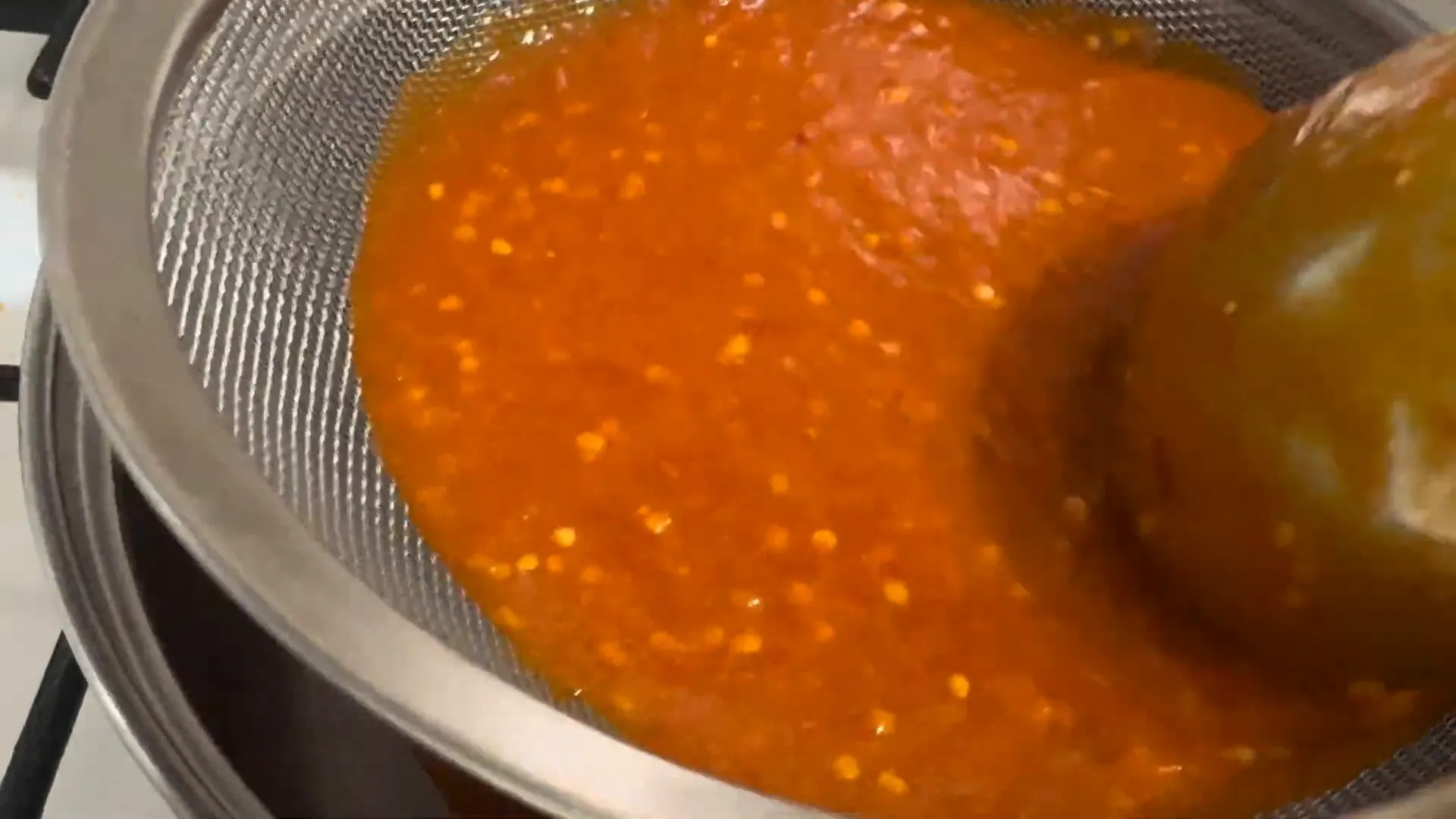 Straining the blended sauce
