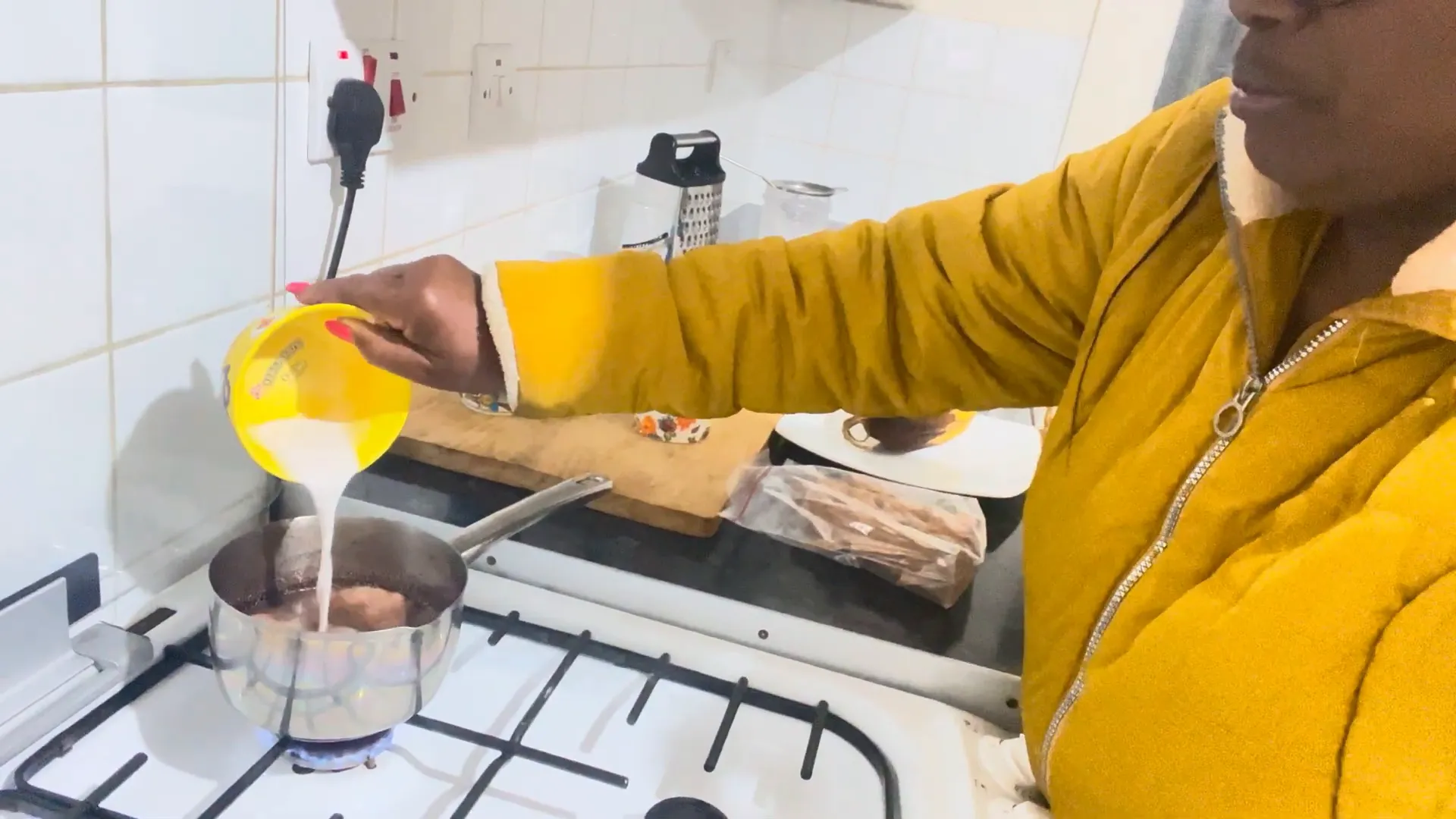 Pouring coconut milk into the chocolate tea