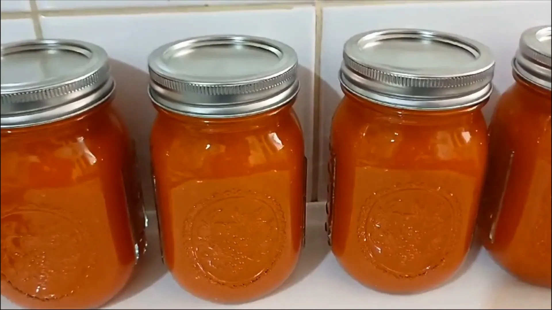 Bottling the pepper sauce into jars
