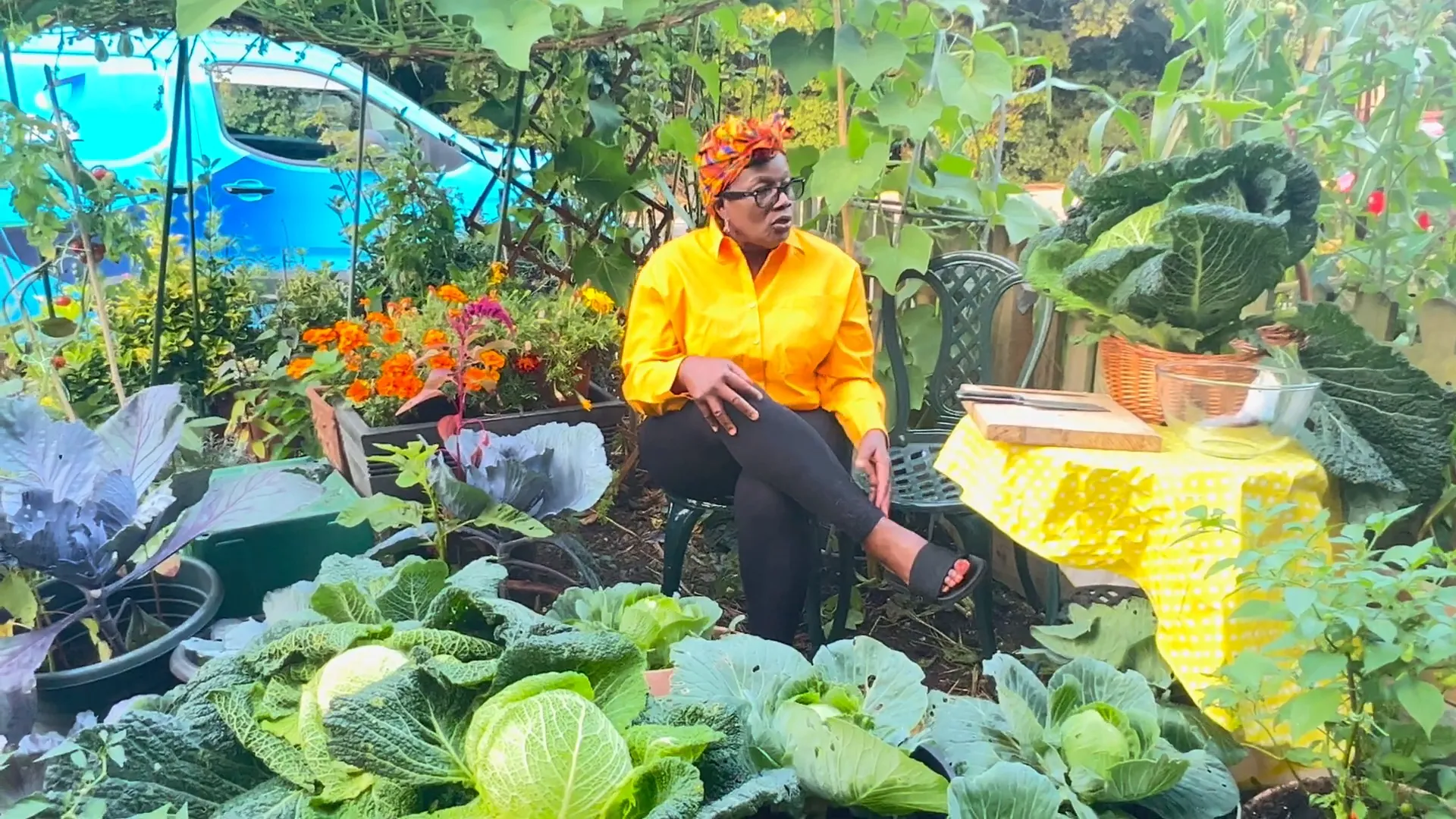 Donna tending to her garden, surrounded by greenery