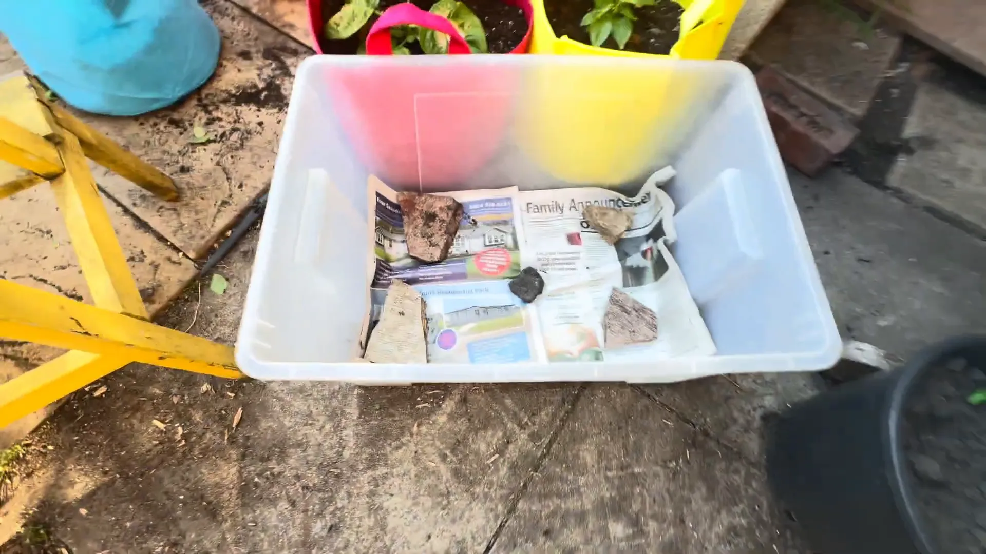 Stones and newspaper layered at the bottom of the container for moisture retention